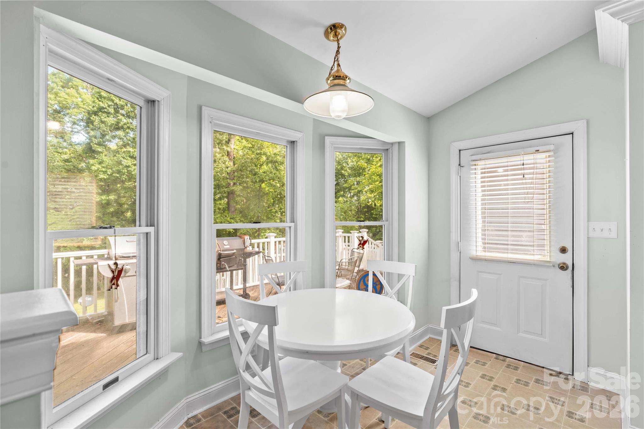 711 Spring Pointe Drive Stony Point, NC 28678 - Photo 14 of 47 a dining room with wooden floor and a chandelier