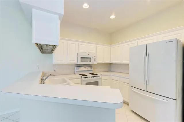 a kitchen with a sink a stove and refrigerator