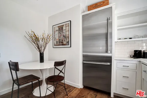 a kitchen with a refrigerator and cabinets