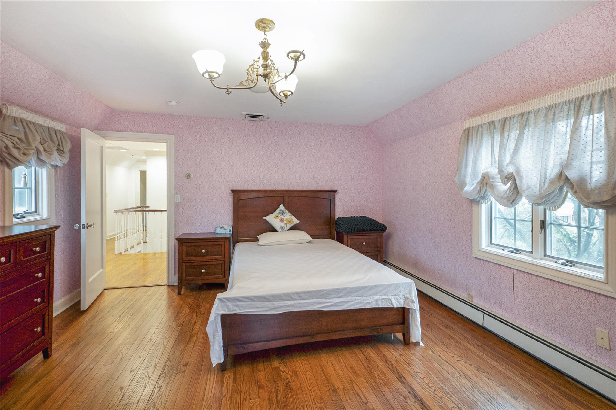 20 Sussex Road Great Neck, NY 11020 - Photo 14 of 27 a bedroom with a bed and wooden floor