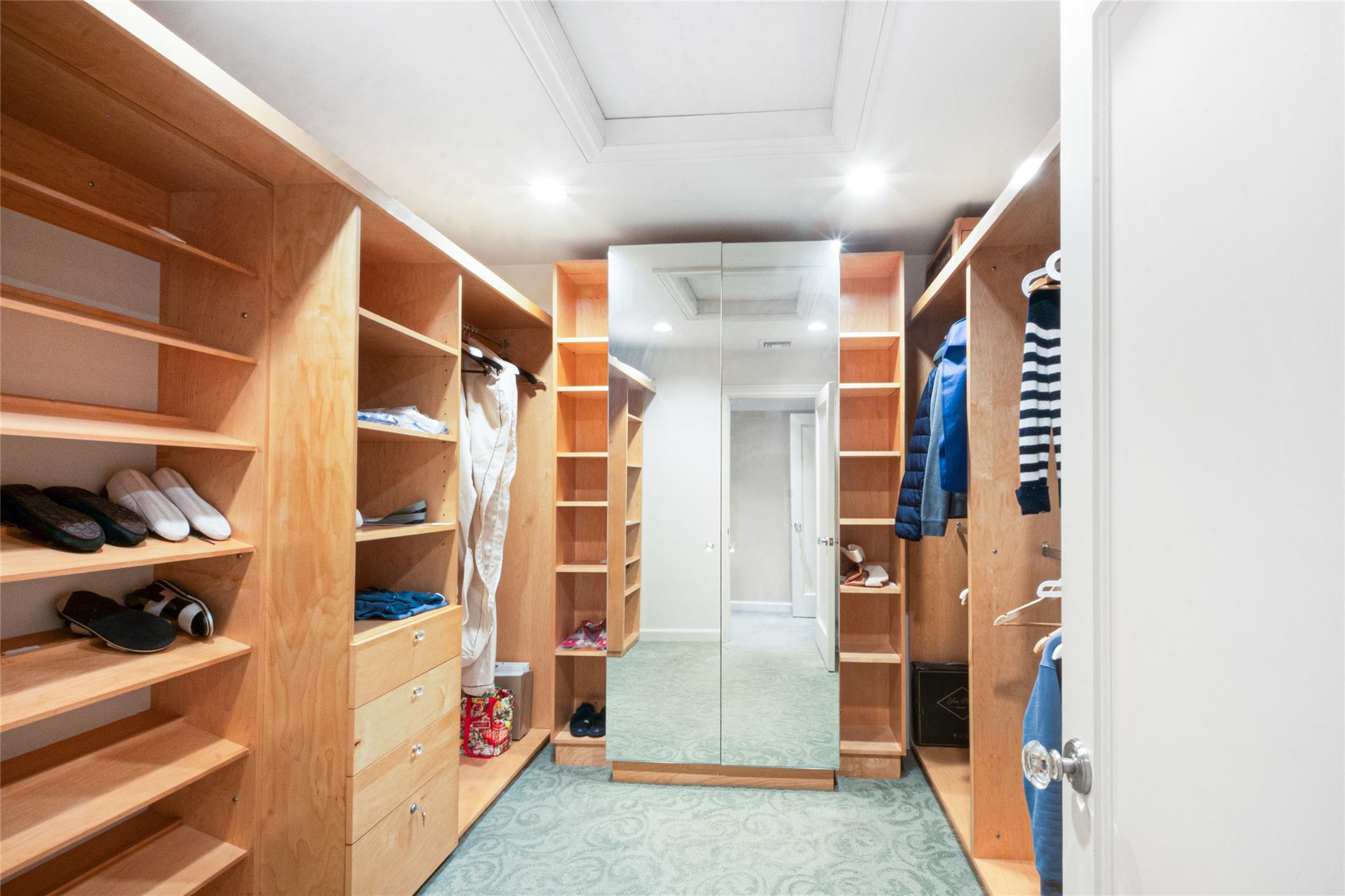 20 Sussex Road Great Neck, NY 11020 - Photo 16 of 27 a view of walk in closet with clothes and shoes
