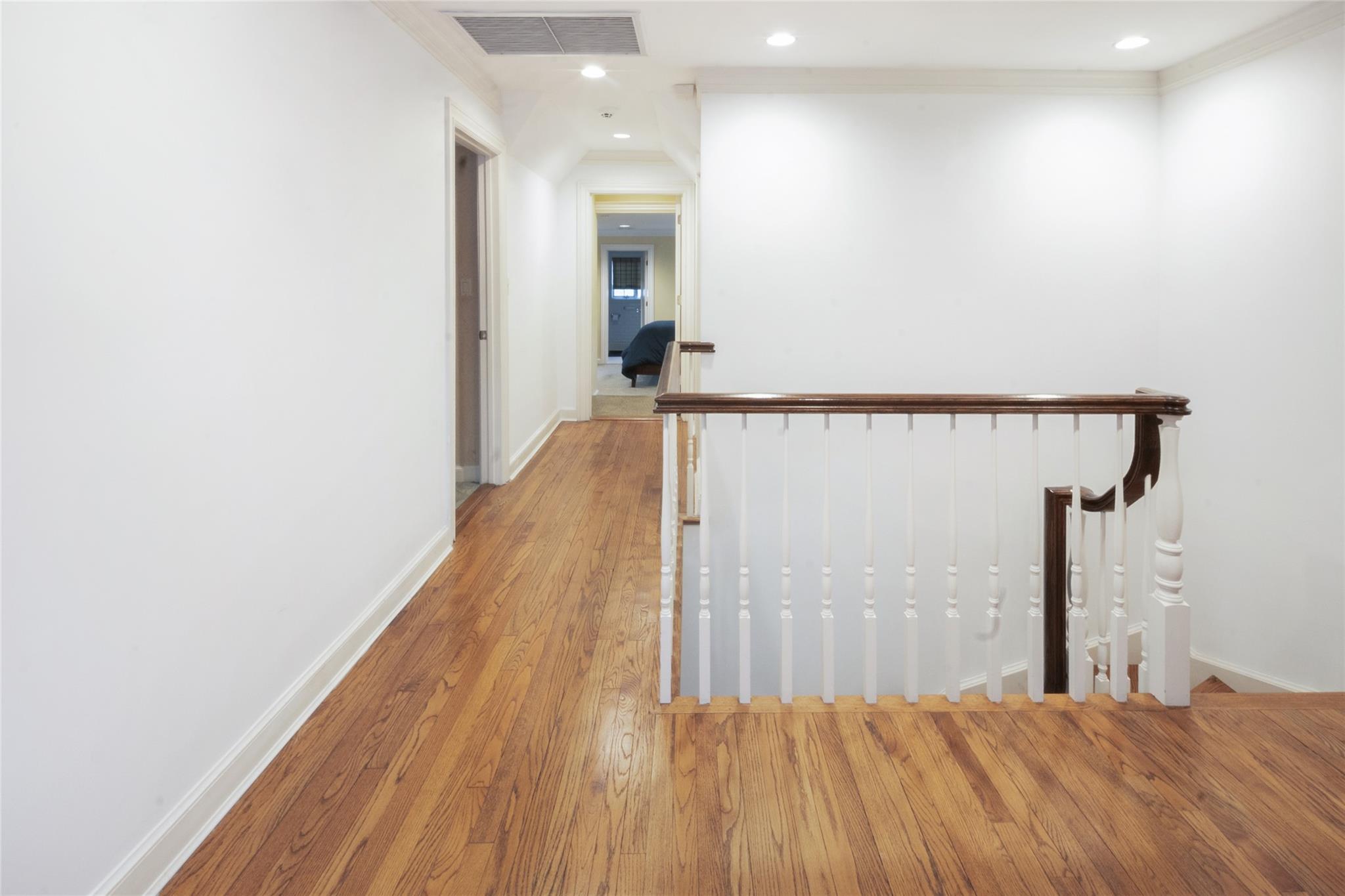 20 Sussex Road Great Neck, NY 11020 - Photo 23 of 27 a view of a hallway with wooden floor and staircase