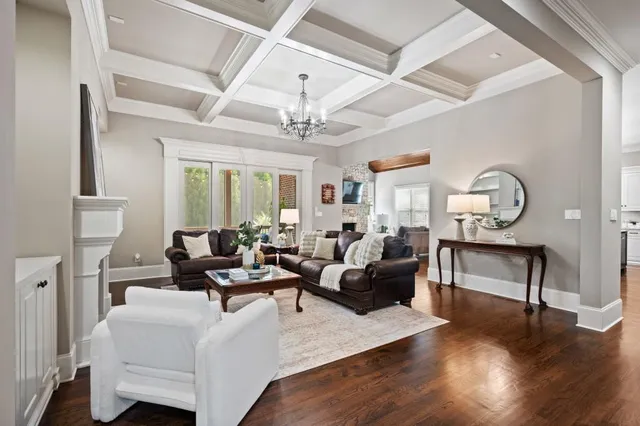 a living room with furniture kitchen and a chandelier