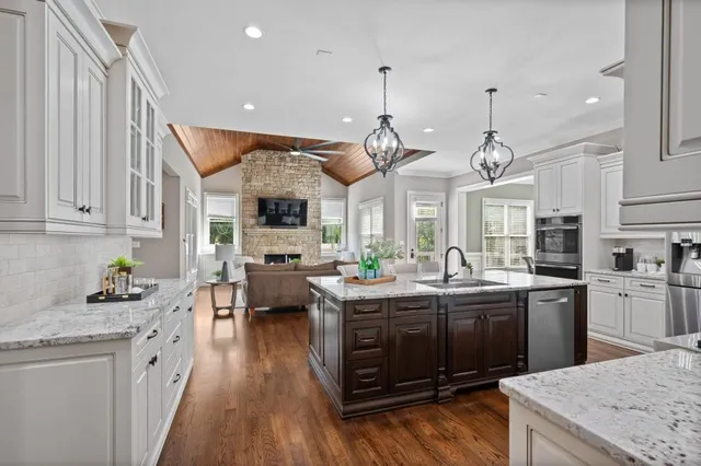 a kitchen with stainless steel appliances granite countertop stove a sink dishwasher and a refrigerator