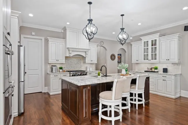 a kitchen with a table chairs stove and cabinets