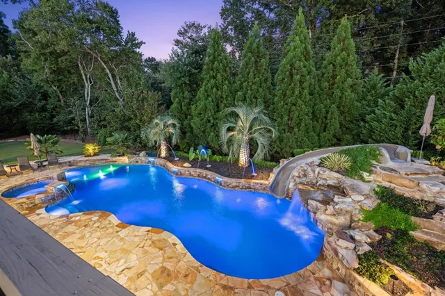 an aerial view of a house with garden space and sitting area