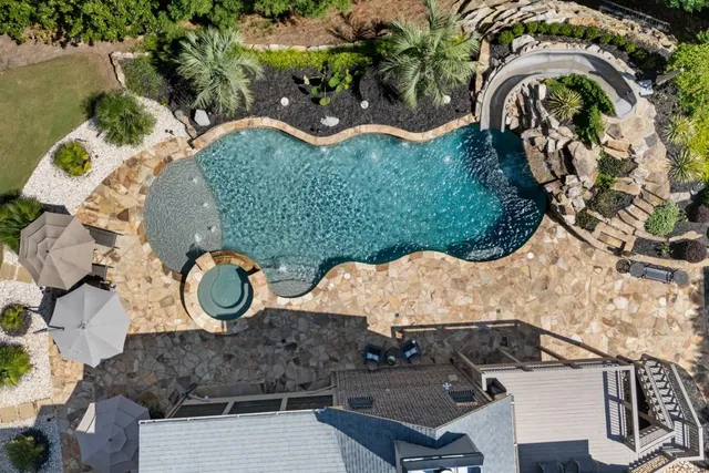a view of patio with chairs and table under an umbrella