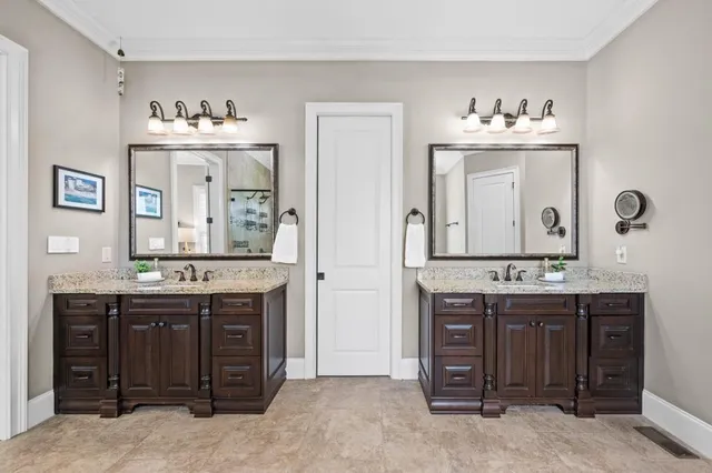a spacious bathroom with a granite countertop double vanity sink mirror and bathtub