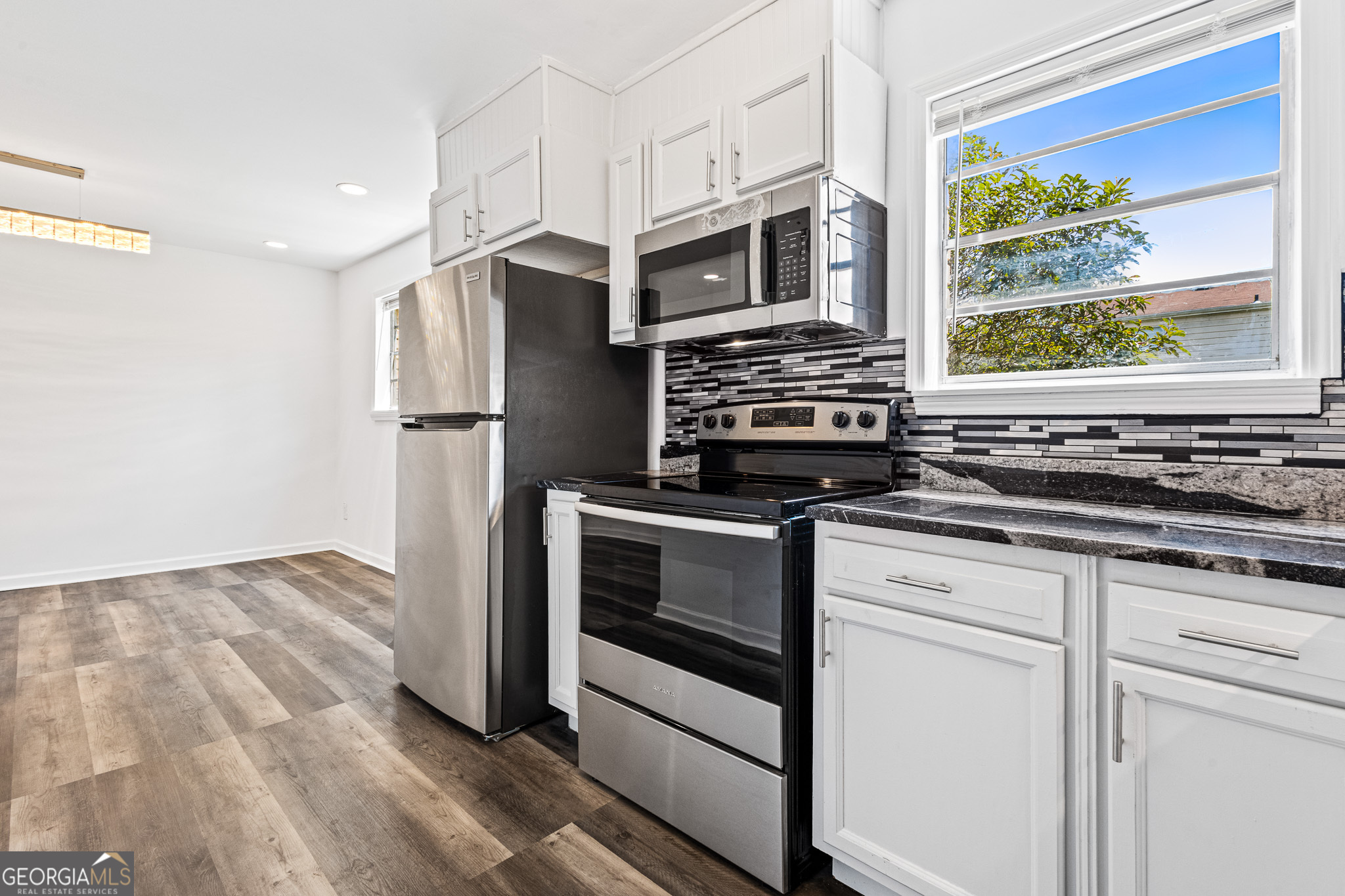 4701 Flat Shoals Road, Unit 47A Union City, GA 30291 - Photo 11 of 29 a kitchen with stainless steel appliances a stove and a refrigerator
