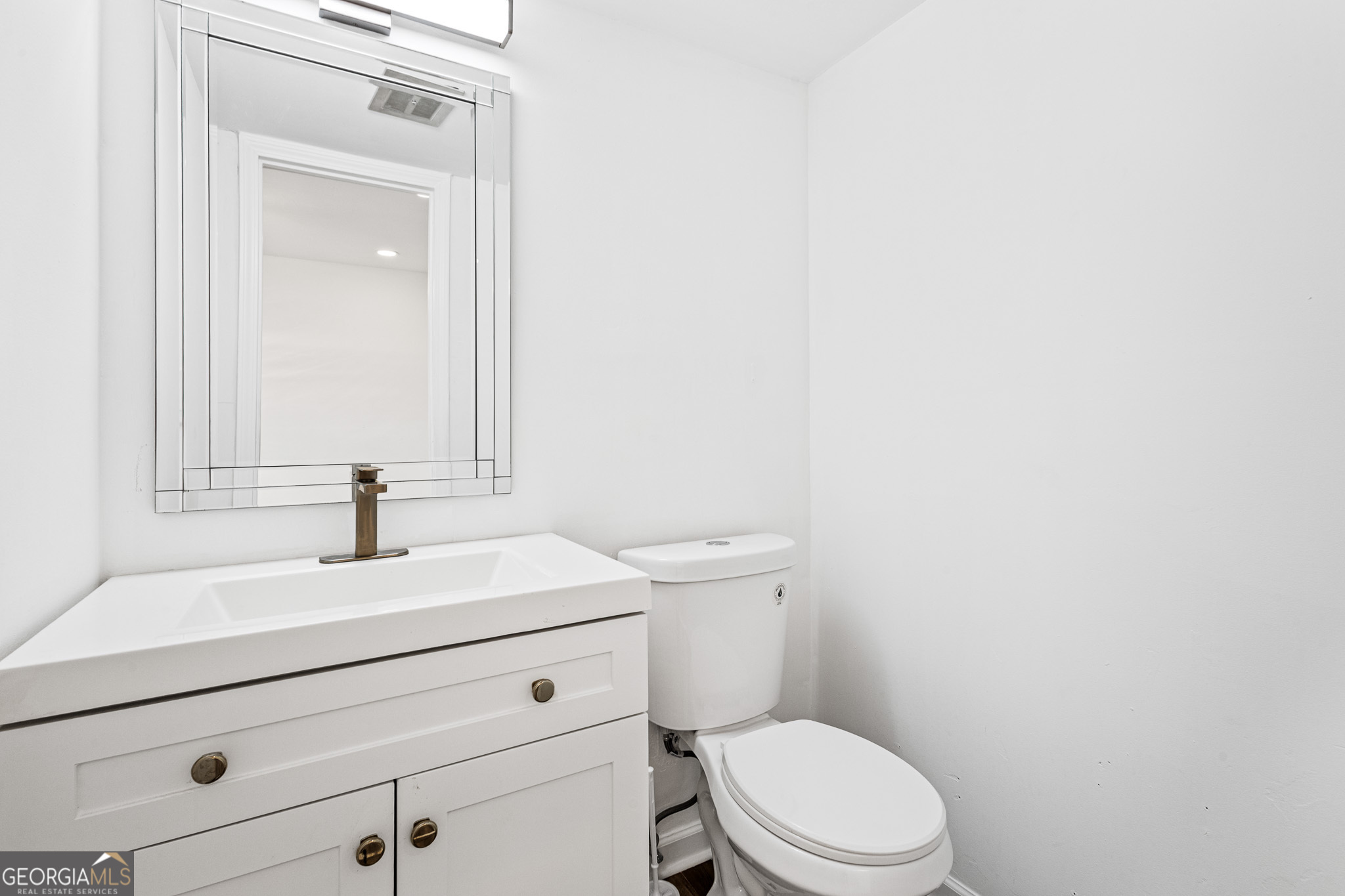 4701 Flat Shoals Road, Unit 47A Union City, GA 30291 - Photo 20 of 29 a bathroom with a sink a toilet and mirror