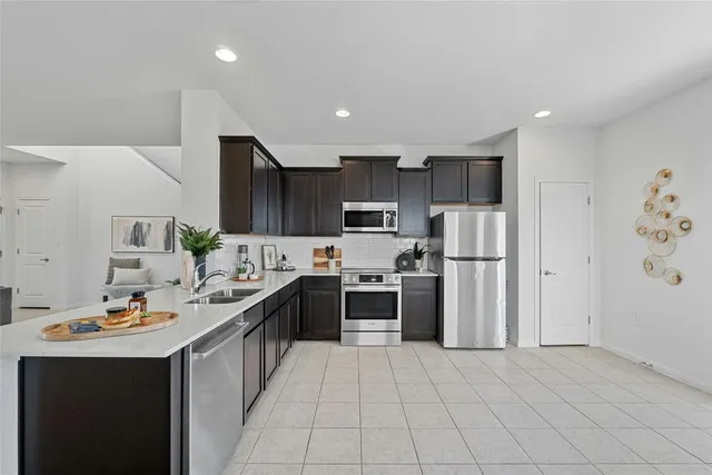 a kitchen with stainless steel appliances a refrigerator stove and sink
