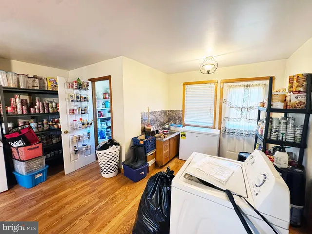 a view of a kitchen with wooden floor and furniture