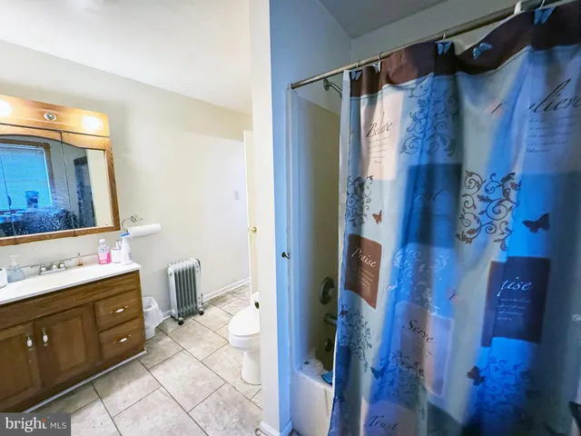 a bathroom with a toilet sink and a mirror