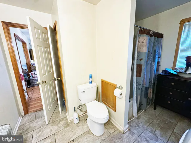 a bathroom with a sink toilet and mirror