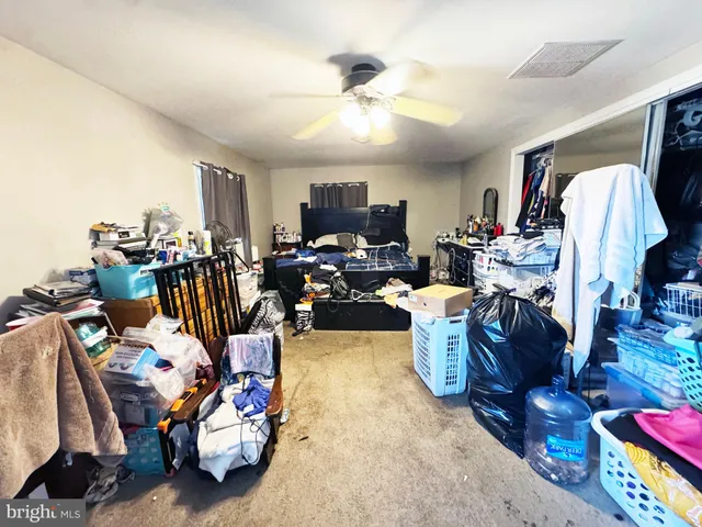 a bed room with a bed furniture and a flat tv screen