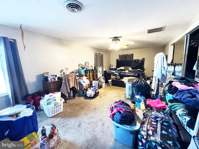 a spacious bedroom with a bed and furniture