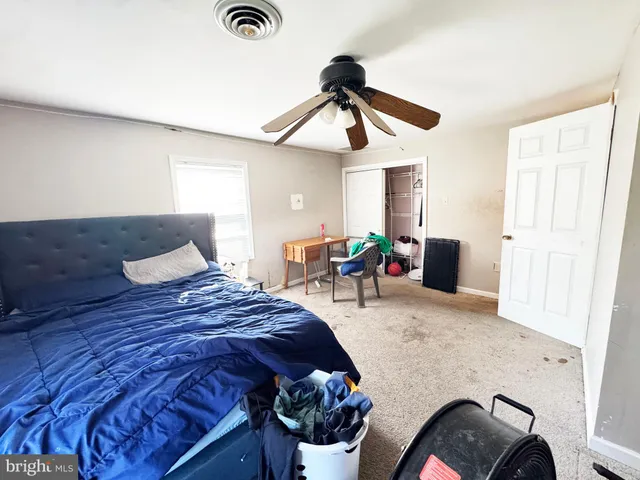 a bedroom with furniture and a flat screen tv