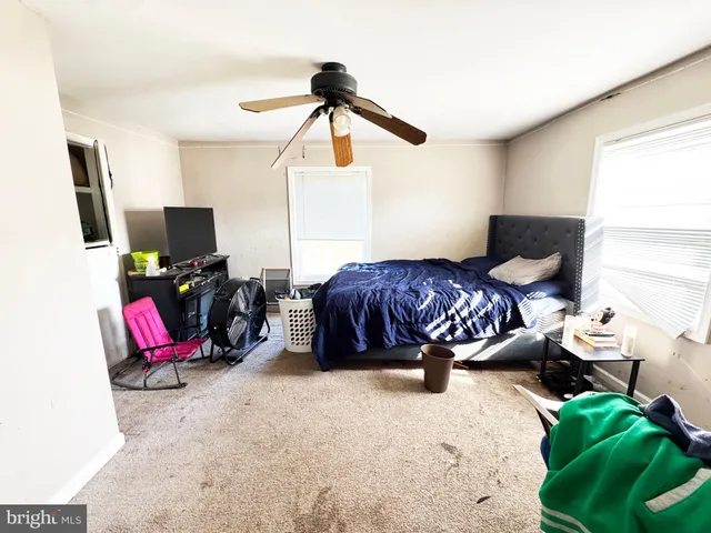 a utility room with wooden floor washer and dryer