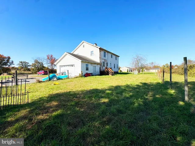 a view of a house with a yard and sitting area