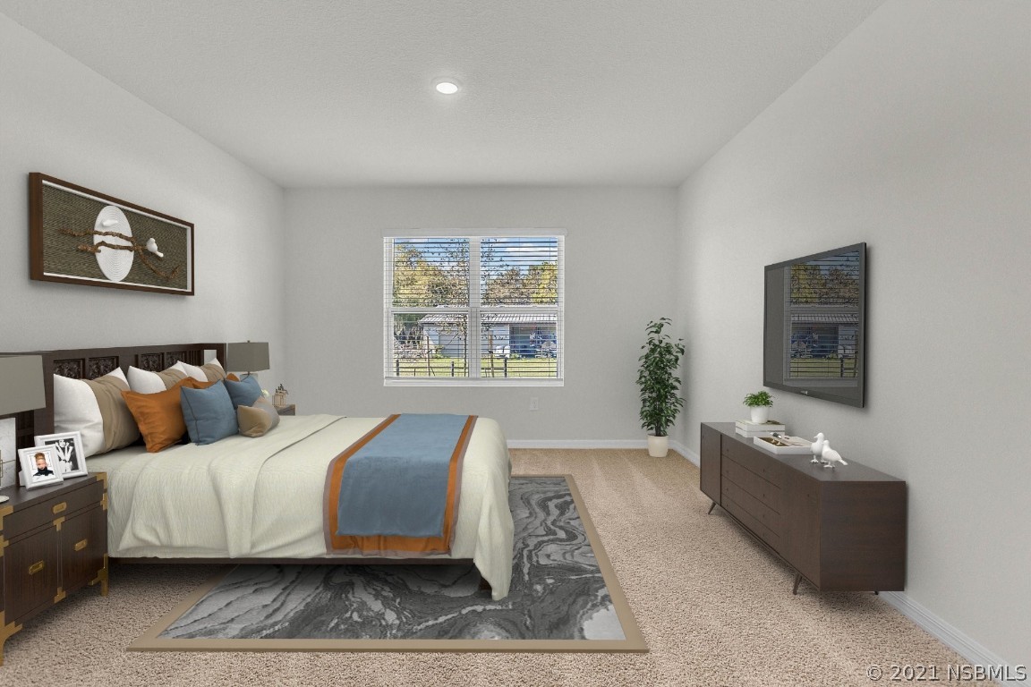 101 Old Mill Pond Road Palm Harbor, FL 34683 - Photo 14 of 20 a bedroom with a bed a couch and window