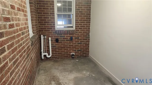 a view of a door and brick wall