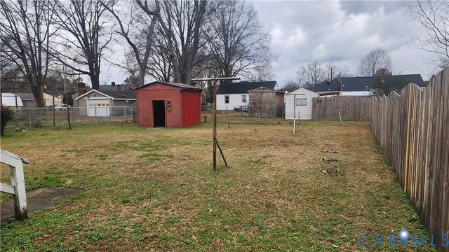 a white house that has a tree in front of it