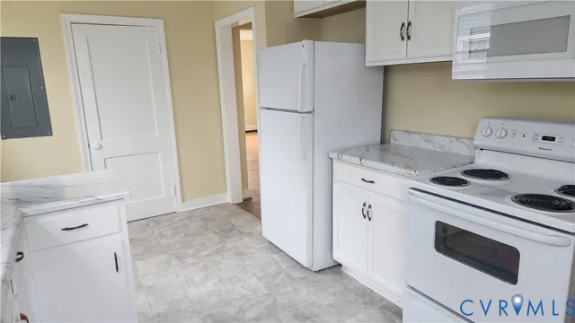 a kitchen with a stove a refrigerator and a sink