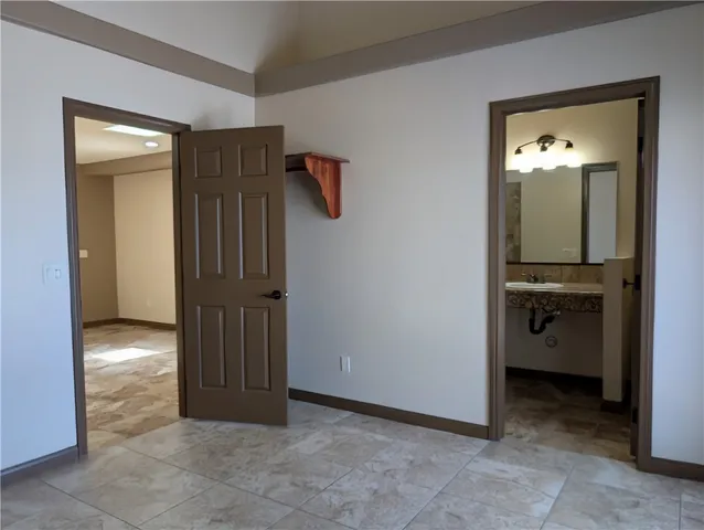 a view of a hallway to closet and a living room
