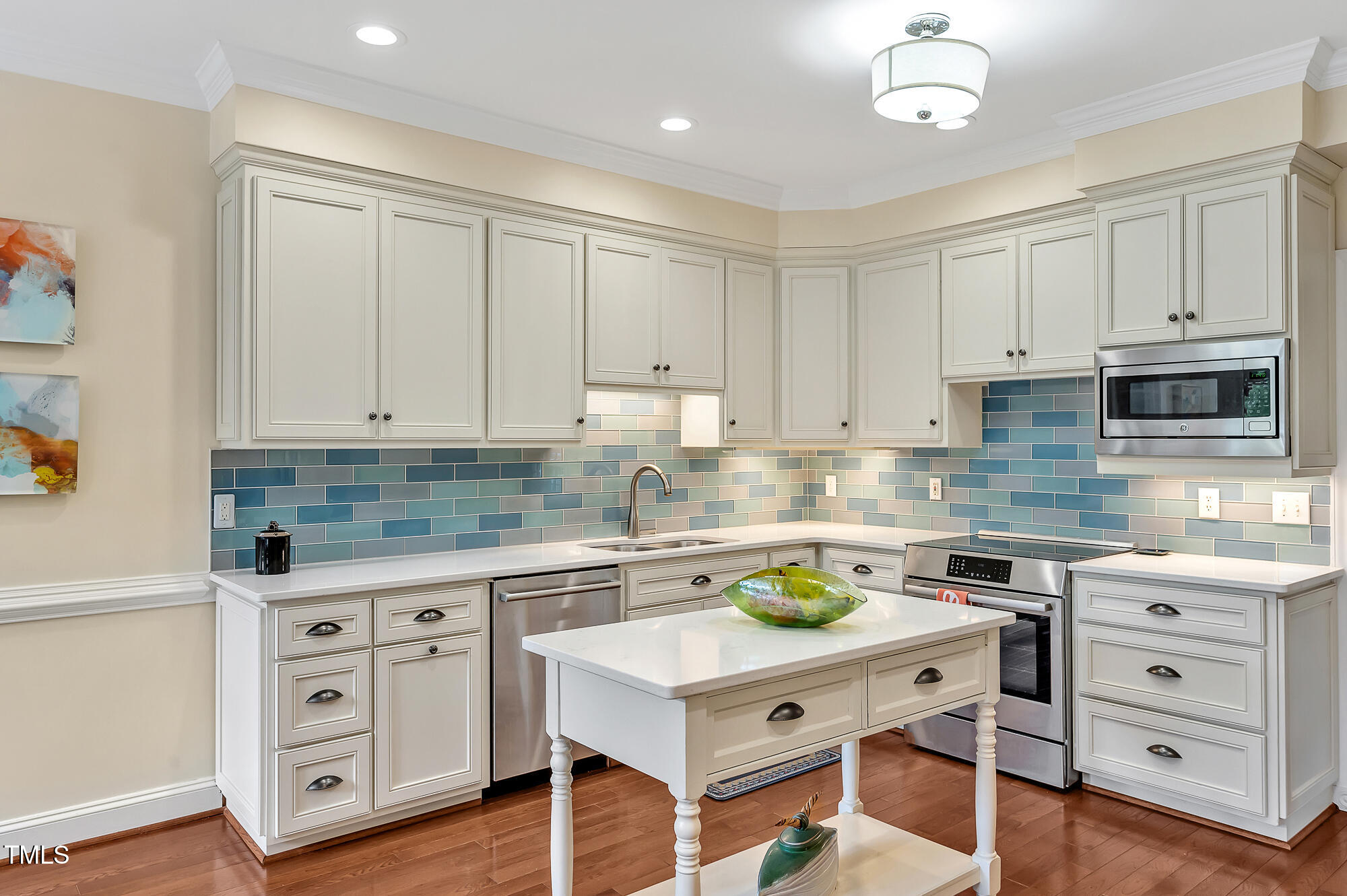 14 Marigold Place Durham, NC 27705 - Photo 15 of 32 a kitchen with white cabinets and white appliances