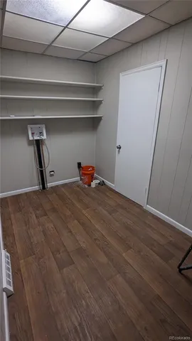 a view of a room with wooden floor