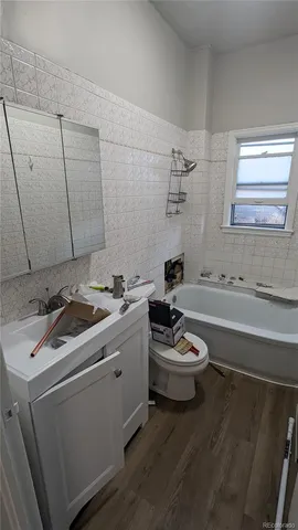 a bathroom with a sink a toilet and bathtub