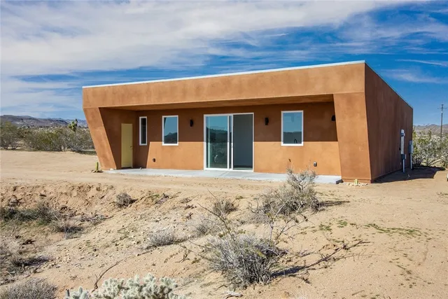 a view of a kitchen with refrigerator and a sink