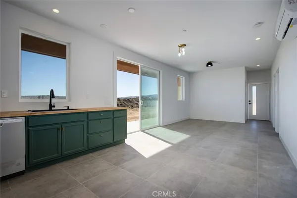 a kitchen with stainless steel appliances granite countertop a refrigerator sink and stove