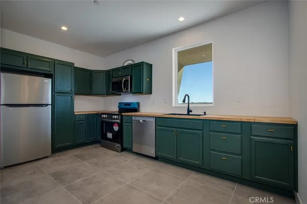 a kitchen with stainless steel appliances granite countertop a refrigerator and a microwave