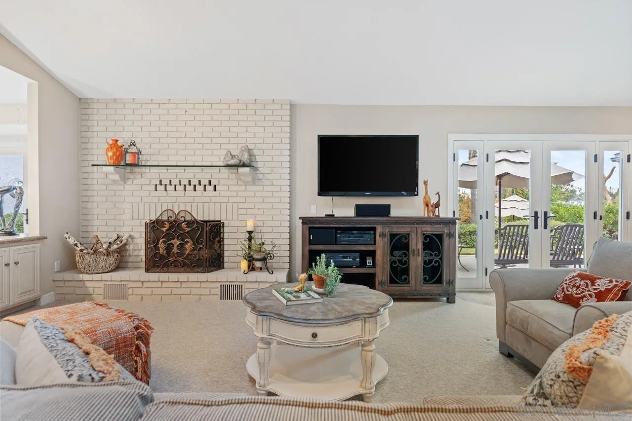 1346 El Nido Drive Fallbrook, CA 92028 - Photo 16 of 75 a living room with furniture a fireplace and a flat screen tv