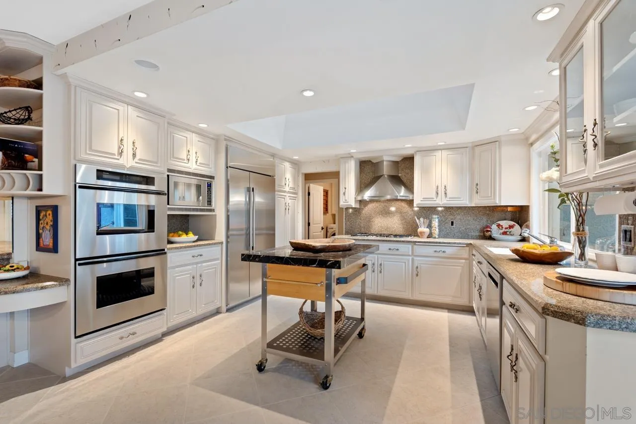 1346 El Nido Drive Fallbrook, CA 92028 - Photo 24 of 75 a kitchen with stainless steel appliances granite countertop a stove top oven a sink dishwasher a refrigerator and cabinets with wooden floor