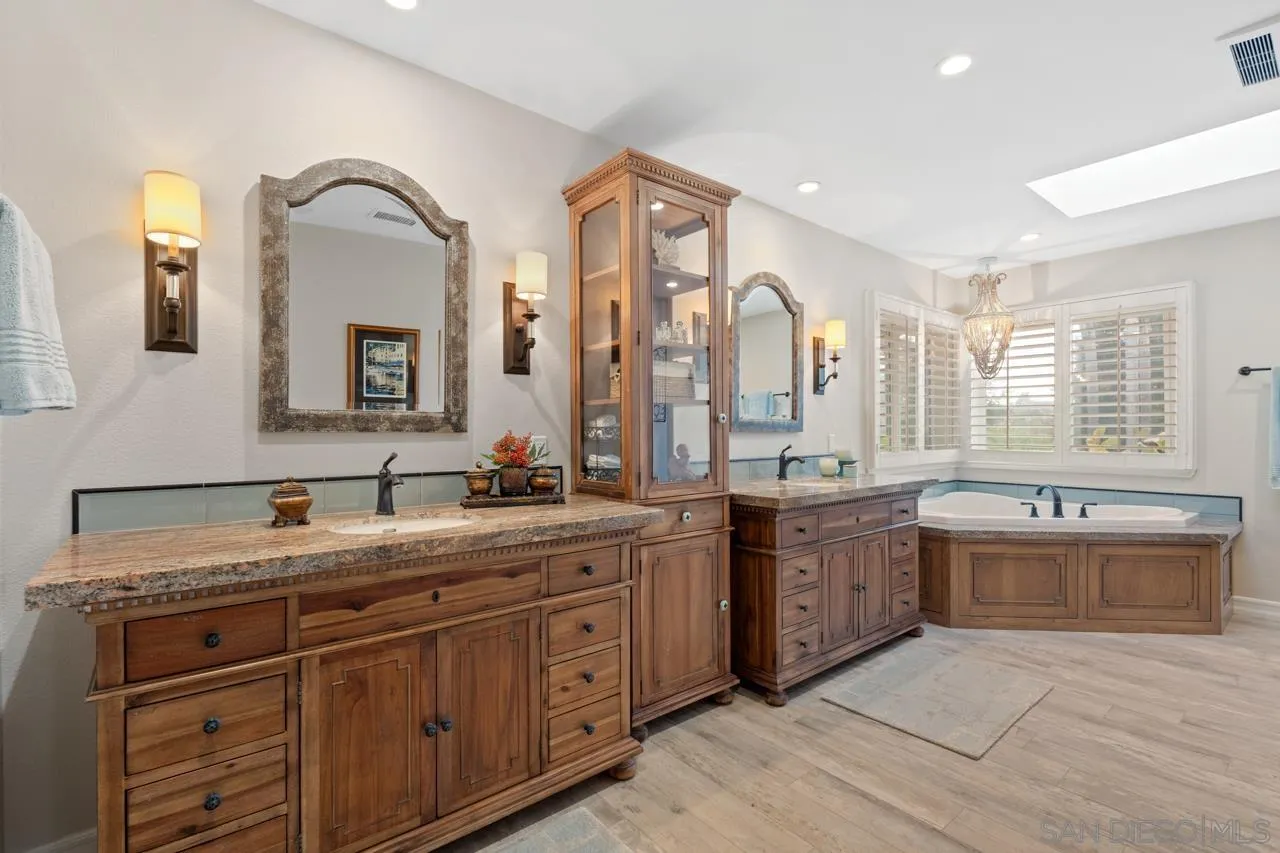 1346 El Nido Drive Fallbrook, CA 92028 - Photo 30 of 75 a large bathroom with double vanity sinks a large mirror and a bathtub