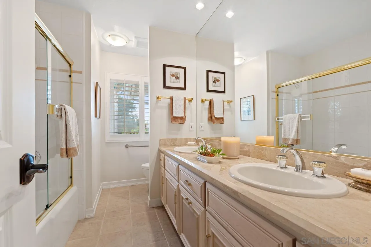 1346 El Nido Drive Fallbrook, CA 92028 - Photo 35 of 75 a bathroom with a double vanity sink a mirror and shower