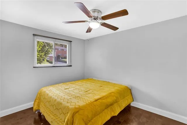 a bed sitting in a bedroom next to a blue wall