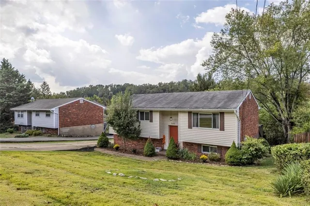 a front view of a house with a yard table and chairs