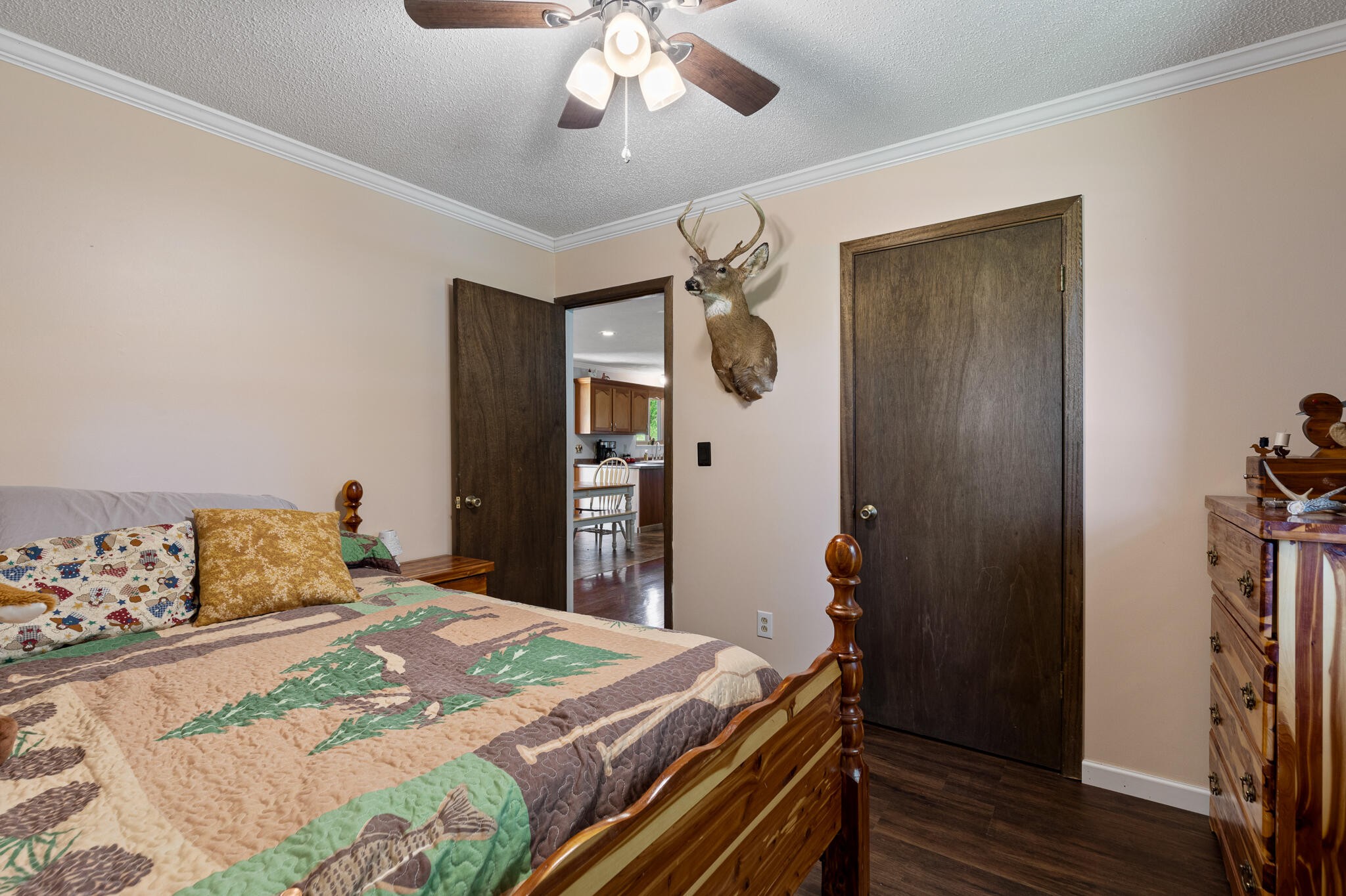 219 Corbin Lake Road Rutledge, TN 37861 - Photo 22 of 41 a bedroom with a bed and a chandelier