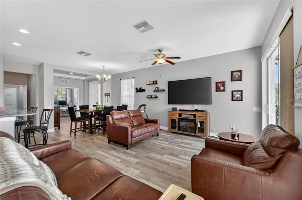 a kitchen with a sink and a flat screen tv