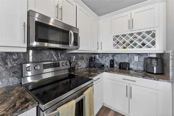 a spacious bathroom with a granite countertop sink a toilet and a shower
