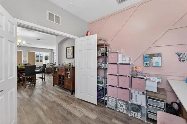 a living room with furniture a flat screen tv and floor to ceiling window