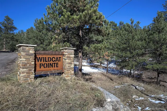 a sign board with buildings in the background