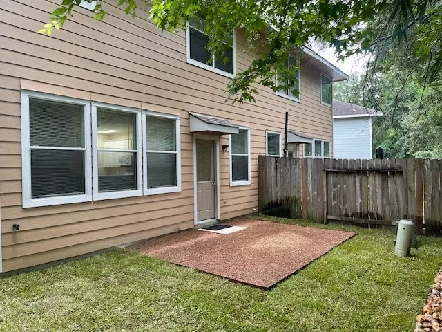 a front view of a house with a yard and fence