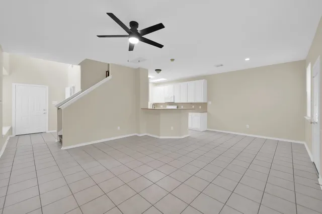 a view of a kitchen with a sink and a refrigerator