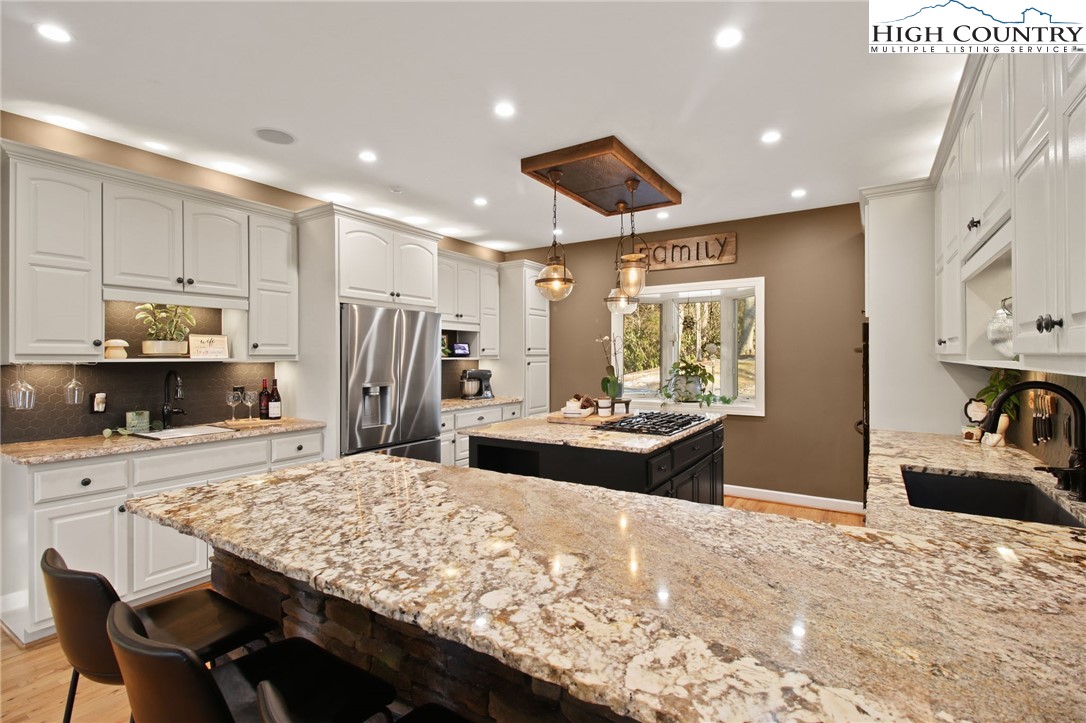 140 Gentry Road Boone, NC 28607 - Photo 23 of 49 a kitchen with kitchen island a sink stove and refrigerator