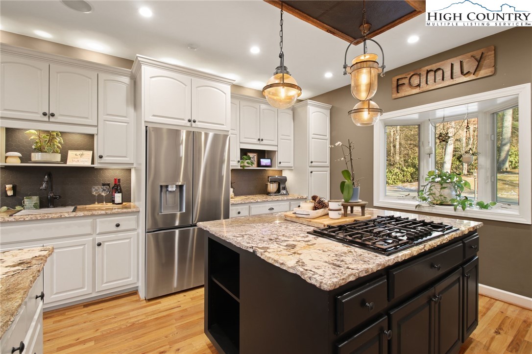 140 Gentry Road Boone, NC 28607 - Photo 25 of 49 a kitchen with a stove a refrigerator and a stove top oven