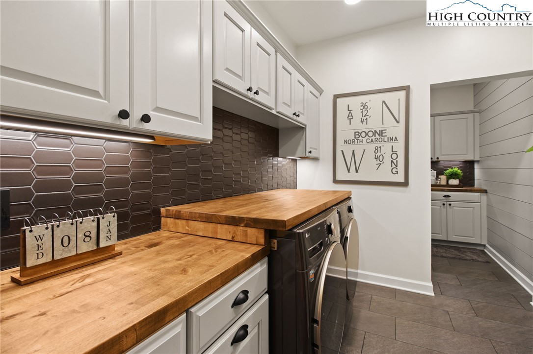 140 Gentry Road Boone, NC 28607 - Photo 26 of 49 a kitchen with stainless steel appliances a stove a sink and a microwave